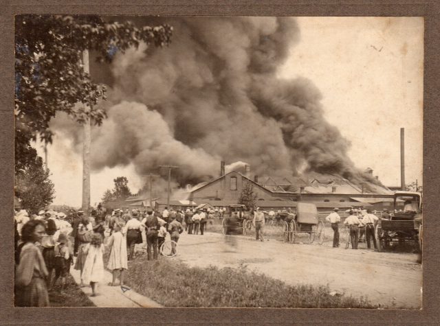 Standard Chain Company factory fire in St Marys, Ohio. July 21, 1906. John W. Kleinhenz would buy this building in 1924 and turn it into the Kleinhenz Union Stockyards.

**STANDARD CHAIN COMPANY**

On Saturday, July 21, a very disastrous fire occurred at the plant of the Standard Chain Company, located at St. Mary's, Ohio. A large brick forge shop was entirely destroyed, together with several other buildings. The engine, boiler and polishing house, as well as the warehouse containing finished stock, were not damaged. As the company operates a number of other plants in various cities some of the St. Mary's Chain makers were transferred to the Braddock plant at Pittsburgh, Pa., and others to the plant at Marion, Ind. A vacant machine shop at St. Mary's was leased by the company and equipped with the necessary machinery transferred from other factories, and within one week from the time of the fire the new plant was in operation, working double turn. Owing to the other plants of the company being so well equipped with reserve machinery and its prompt action in transferring it no serious interruption occurred in the production of Chain or in shipments to customers. As soon as the insurance loss is adjusted the plant will be rebuilt on an enlarged scale.